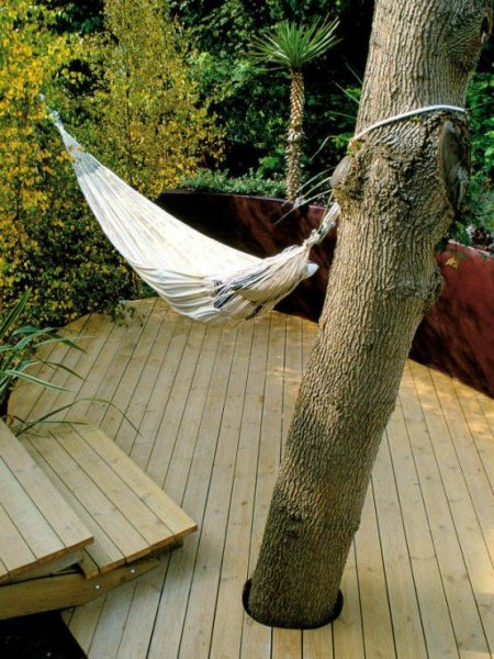 35-Inspiring-Outdoor-Deck-Designs-with-white-hanging-bed-and-stair-with-big-tree-and-hardwood-floor